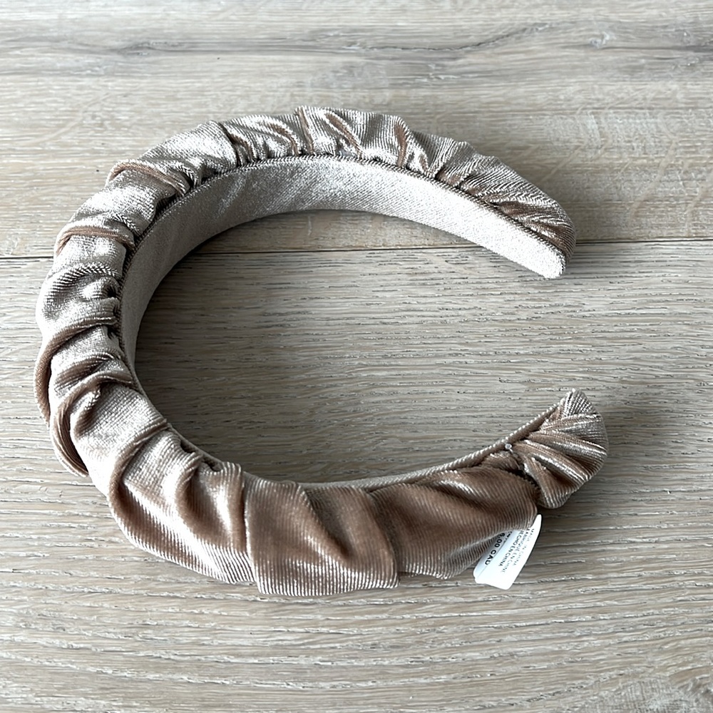 Brand new beige headband from Anthropologie with tag attached.